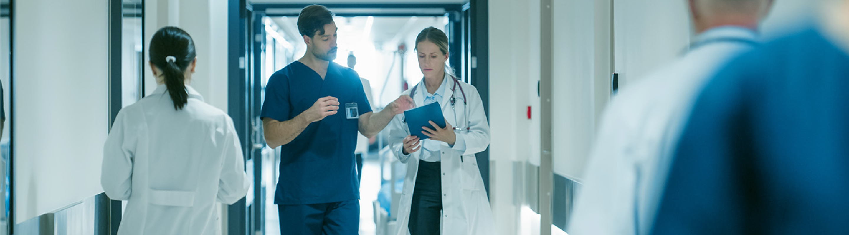Healthcare providers in hospital corridor